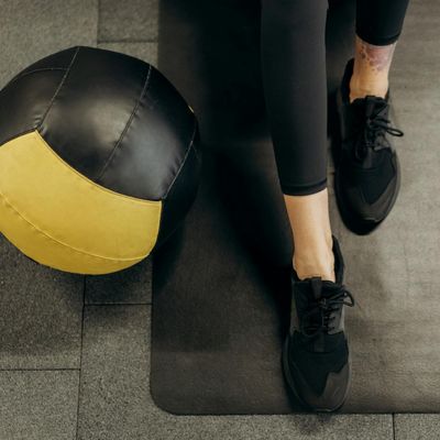 A person's feet in athletic shoes on a clean floor.